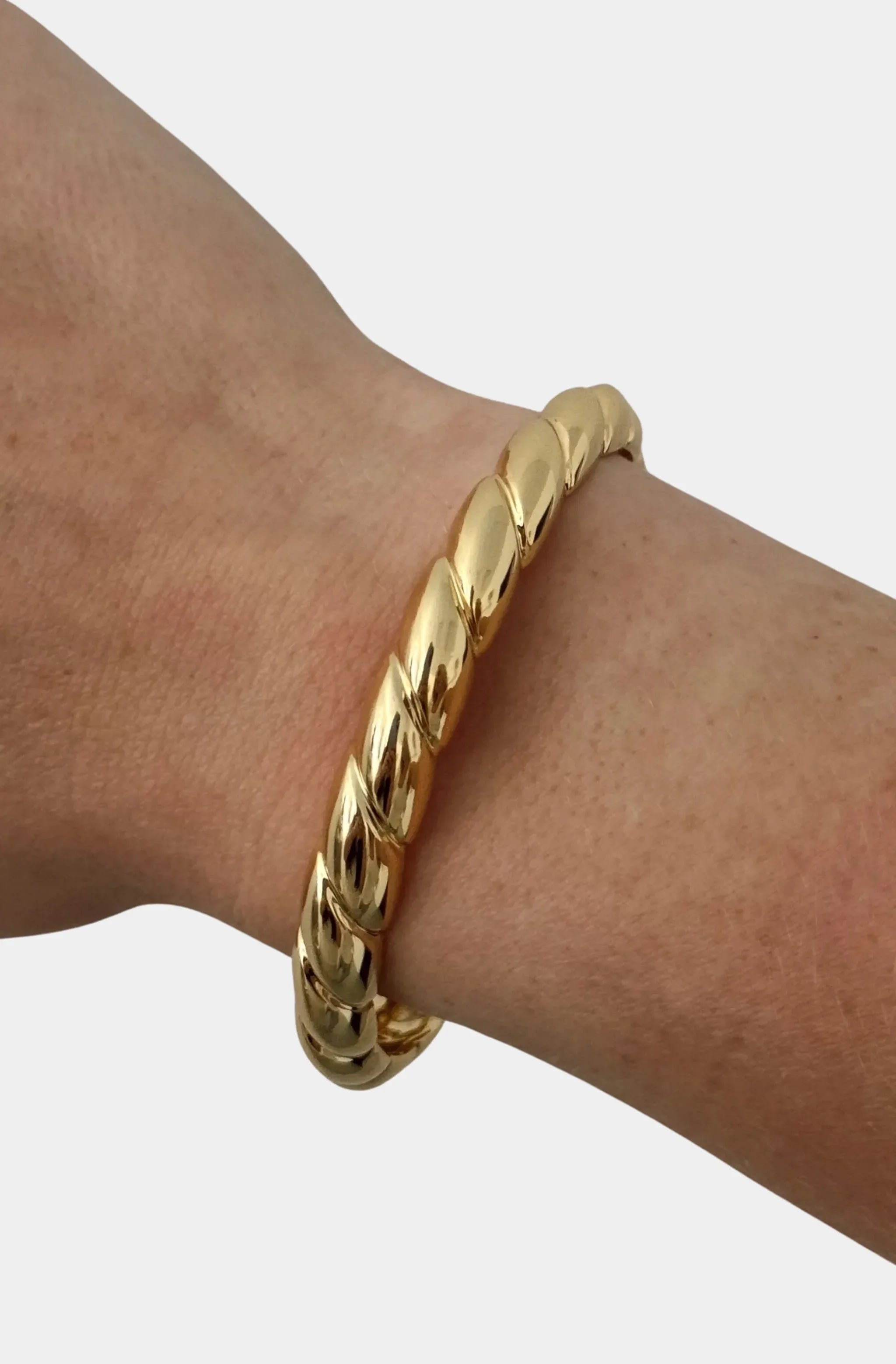 Elegant gold cuff bracelet on wrist