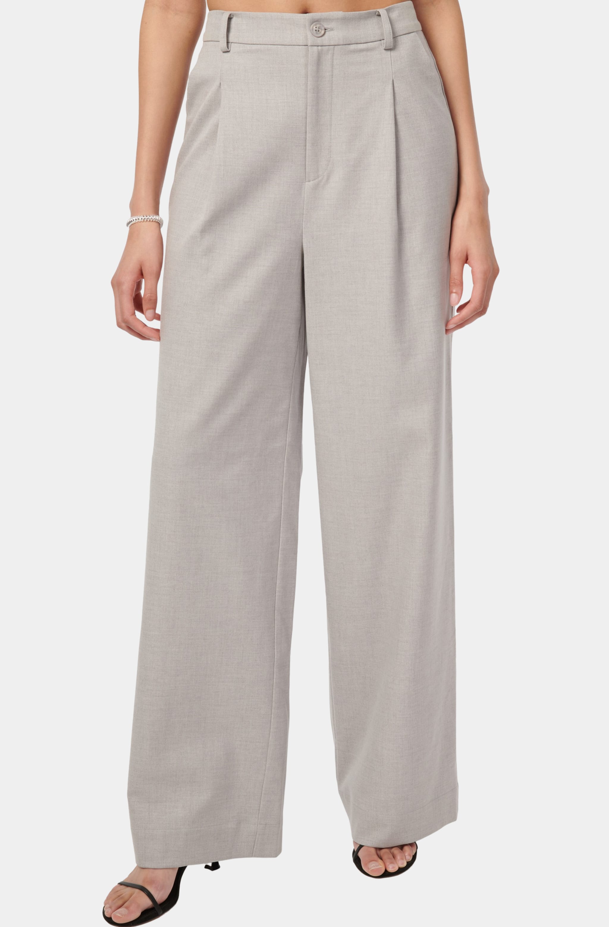 Close-up of high-waisted wide-leg pants in light gray.