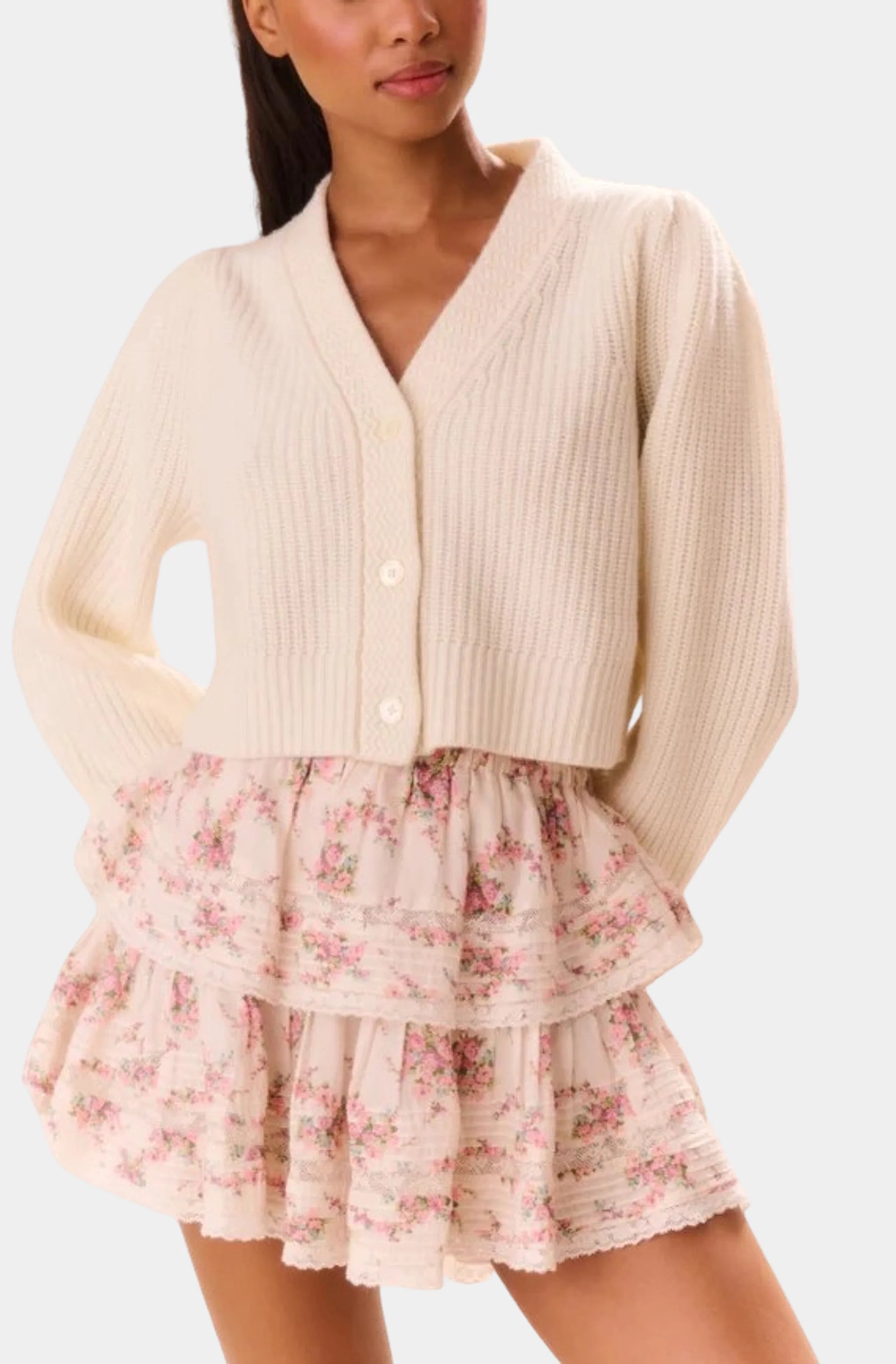 Floral ruffle mini skirt with elastic waist, styled with cream sweater.