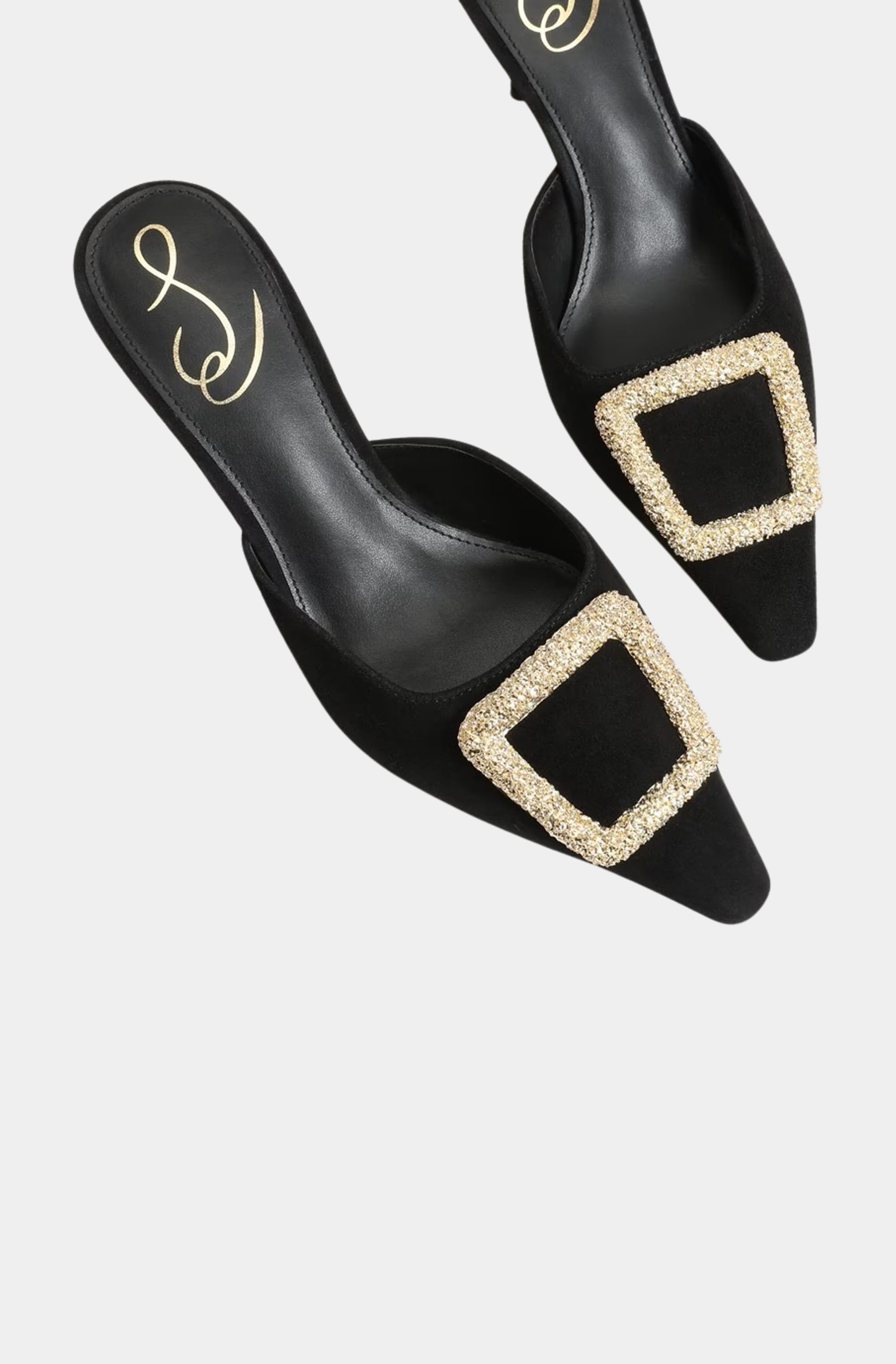 Top view of black mules with pointed toe and gold buckle