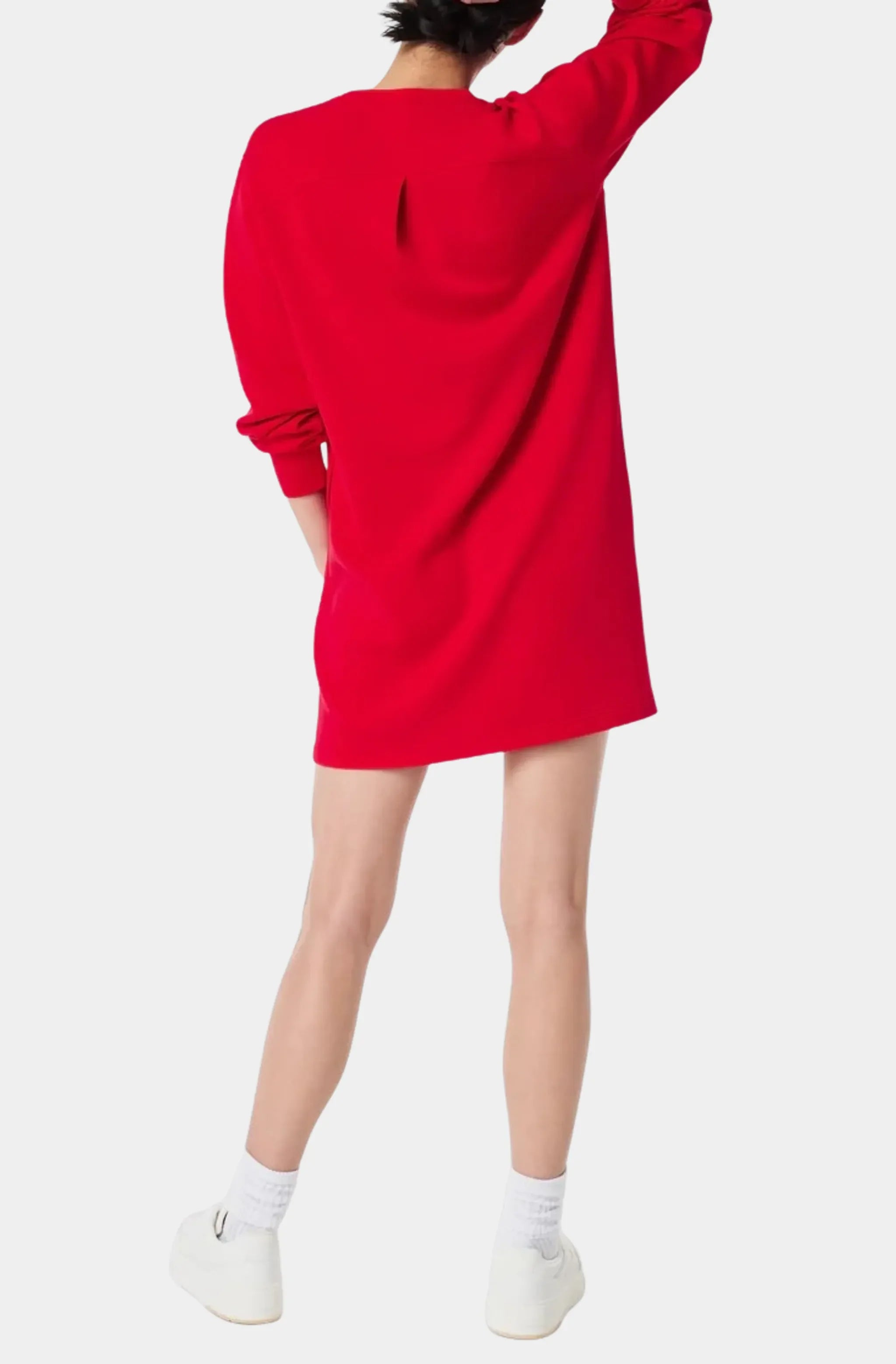 Back view of red dress with long sleeves and sneakers